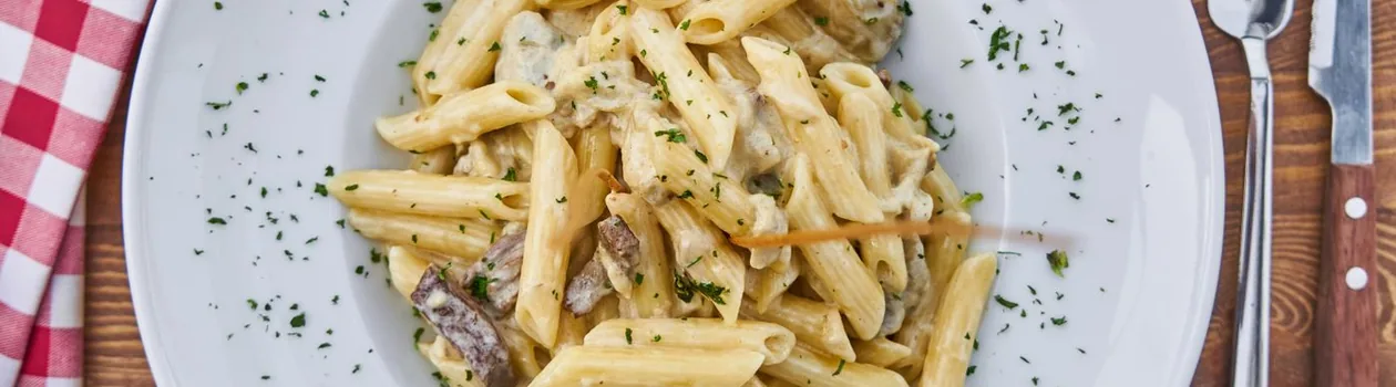 A plate of fresh Italian pasta on a wooden table