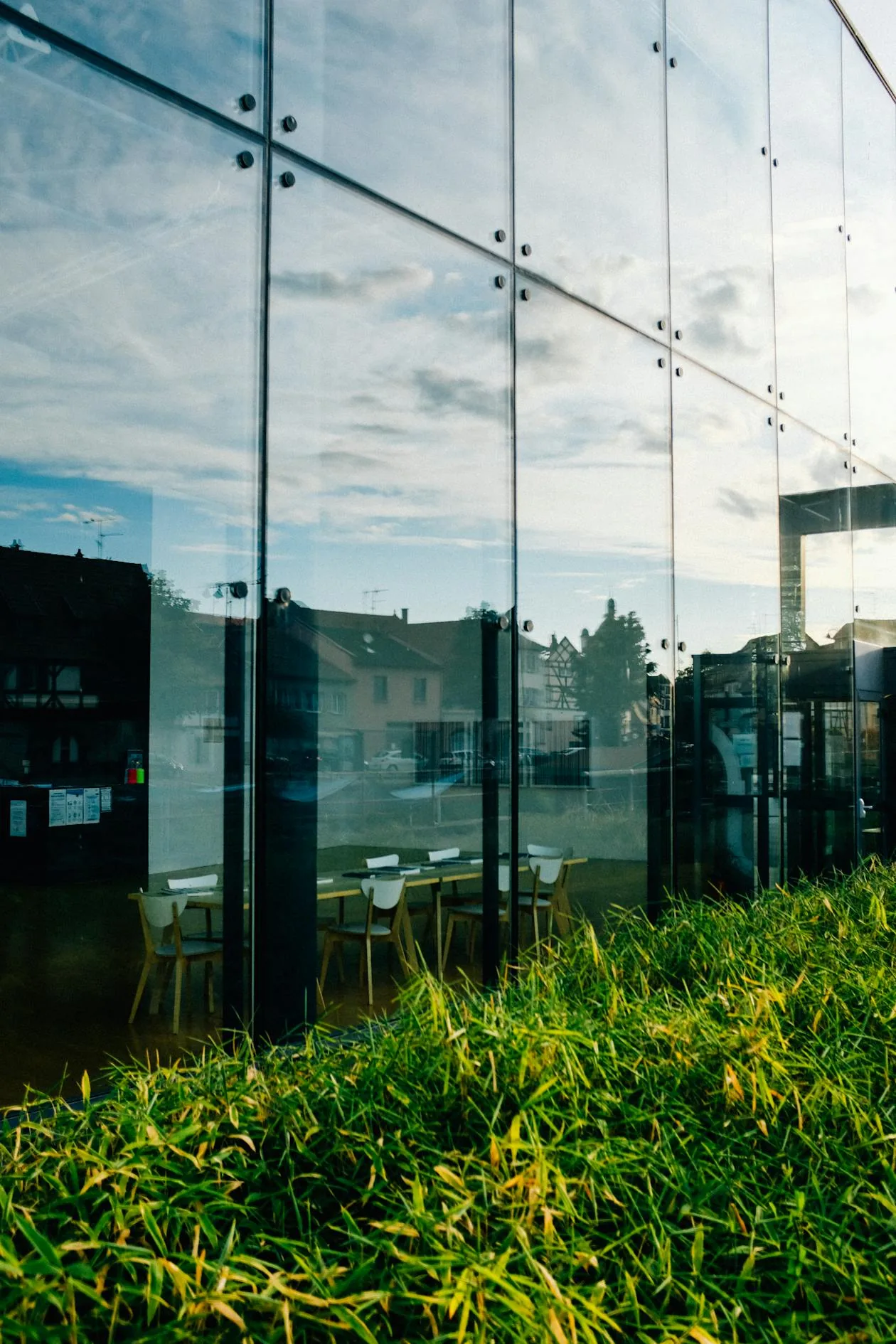 CCCB courtyard with glass facade reflecting the historic Casa de Caritat building