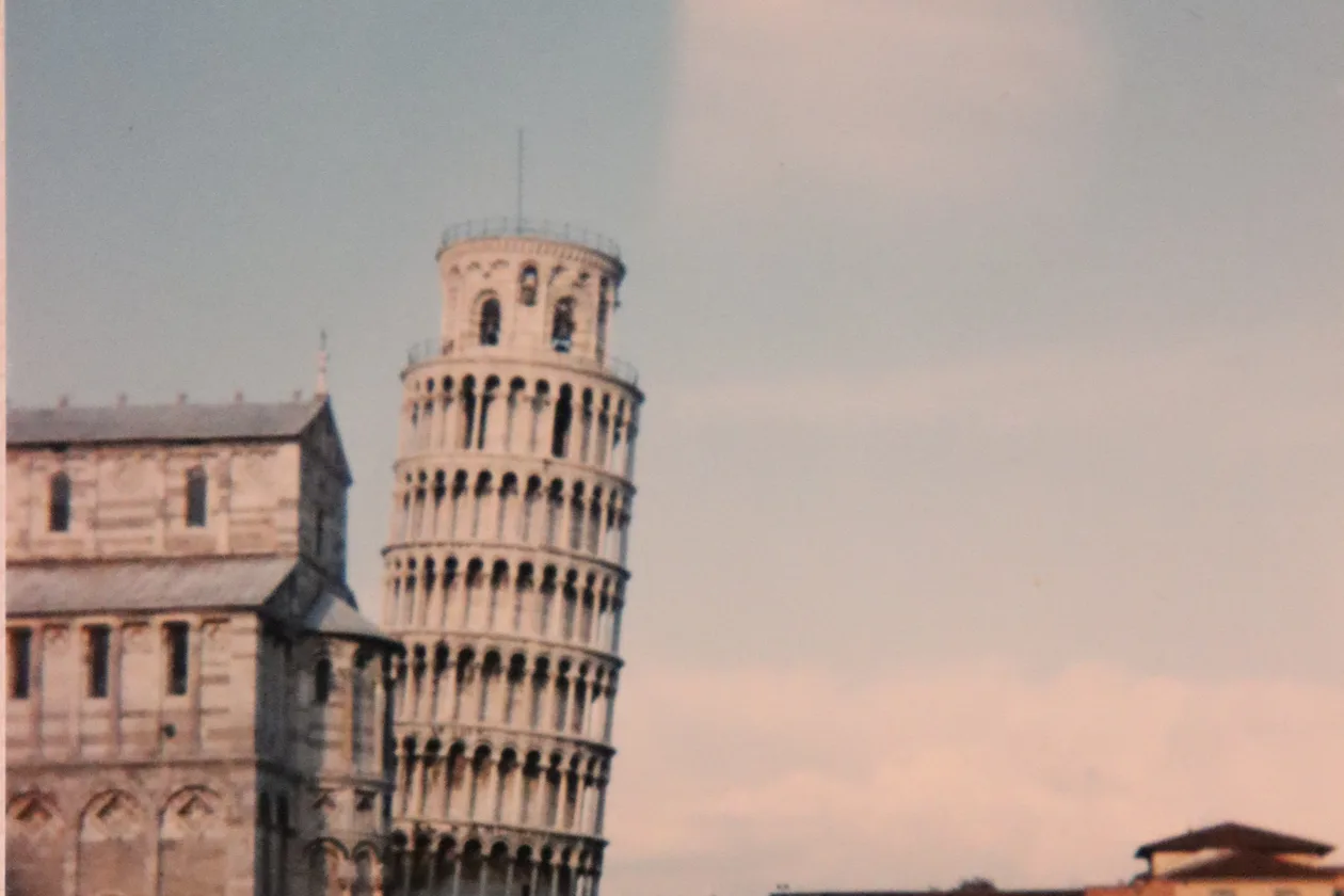 Piazza dei Miracoli, Pisa — the Leaning Tower and Baptistery rising above the green lawn of the Campo dei Miracoli