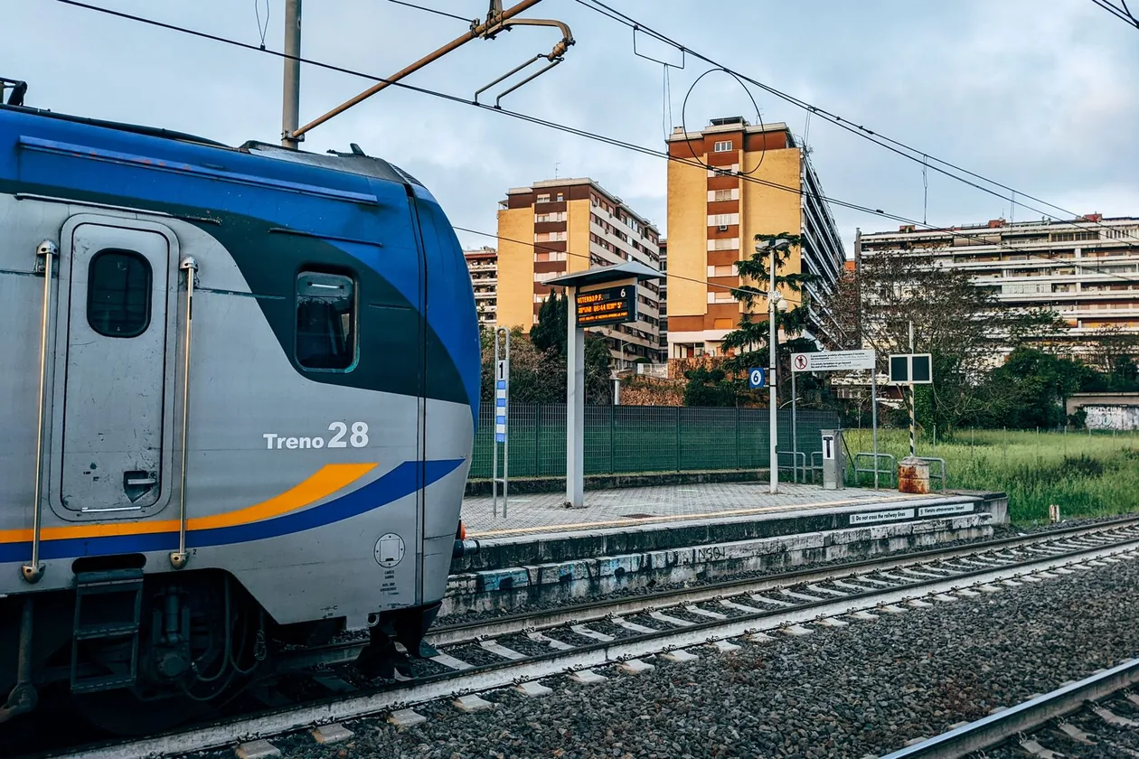 Trenitalia regional train at a suburban station platform in Rome